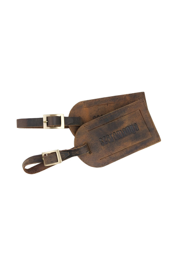 Brown leather luggage tags with buckle straps and vintage distressed finish
