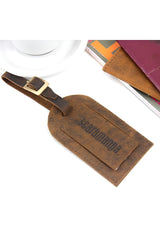 Brown leather luggage tag with strap and buckle detail angled view